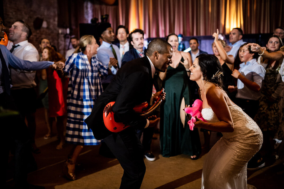 San Francisco Bay Area wedding photographer captures energetic dance floor celebration with bride and groom surrounded by guests at Estate Yountville in Napa Valley