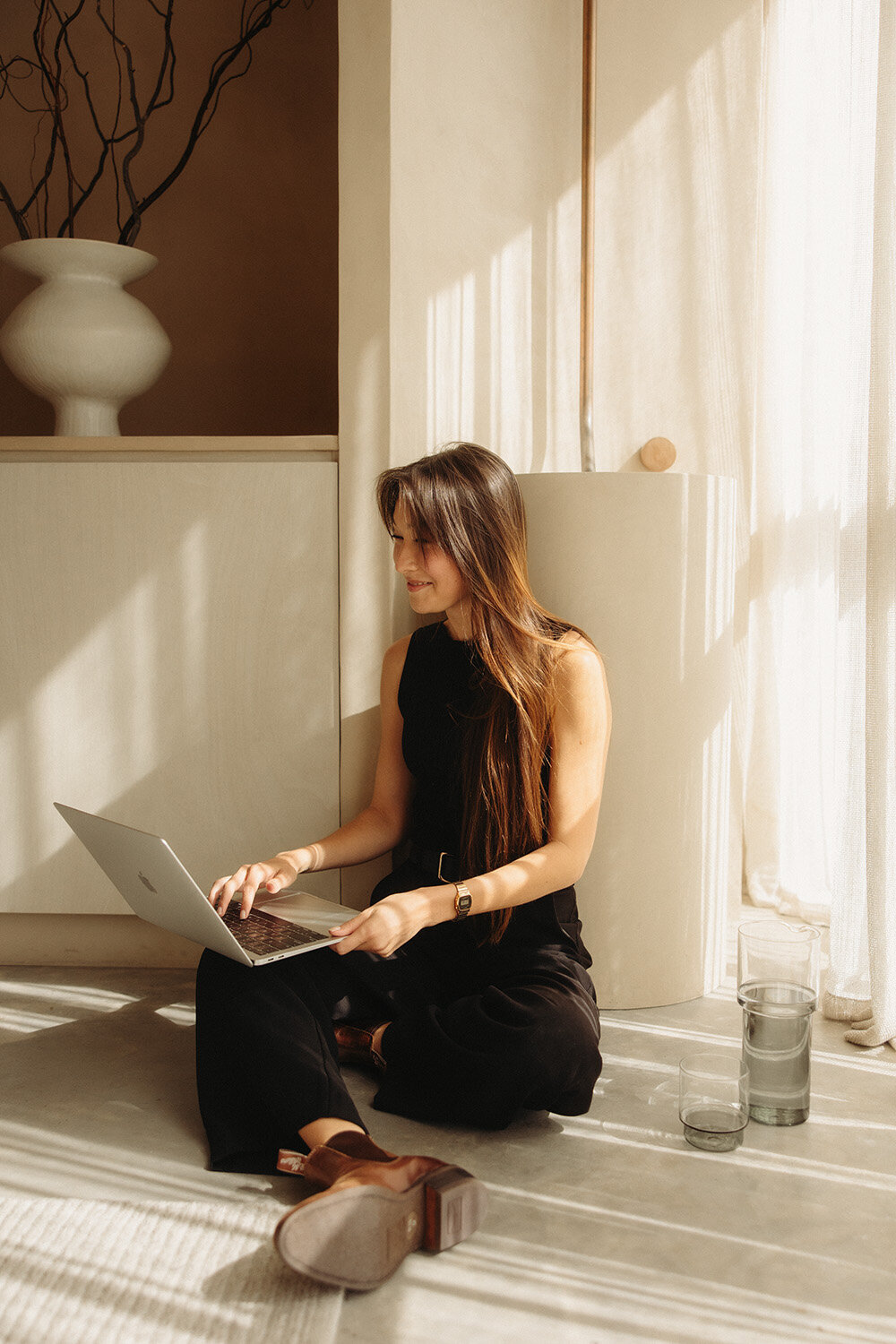 Professional branding photography for a small business owner, featuring a relaxed and natural headshot in a warm, inviting space.