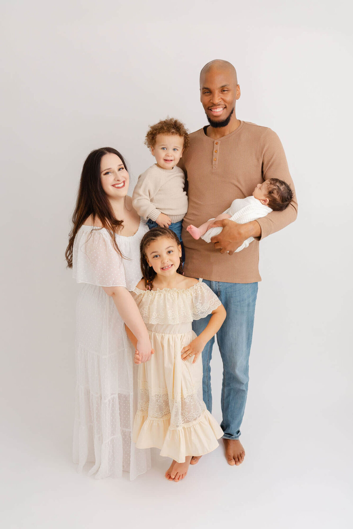 Family of 5 all standing for a formal portrait during newborn photo session at Ashlie Behm Photography's portrait studio in SE Portland.