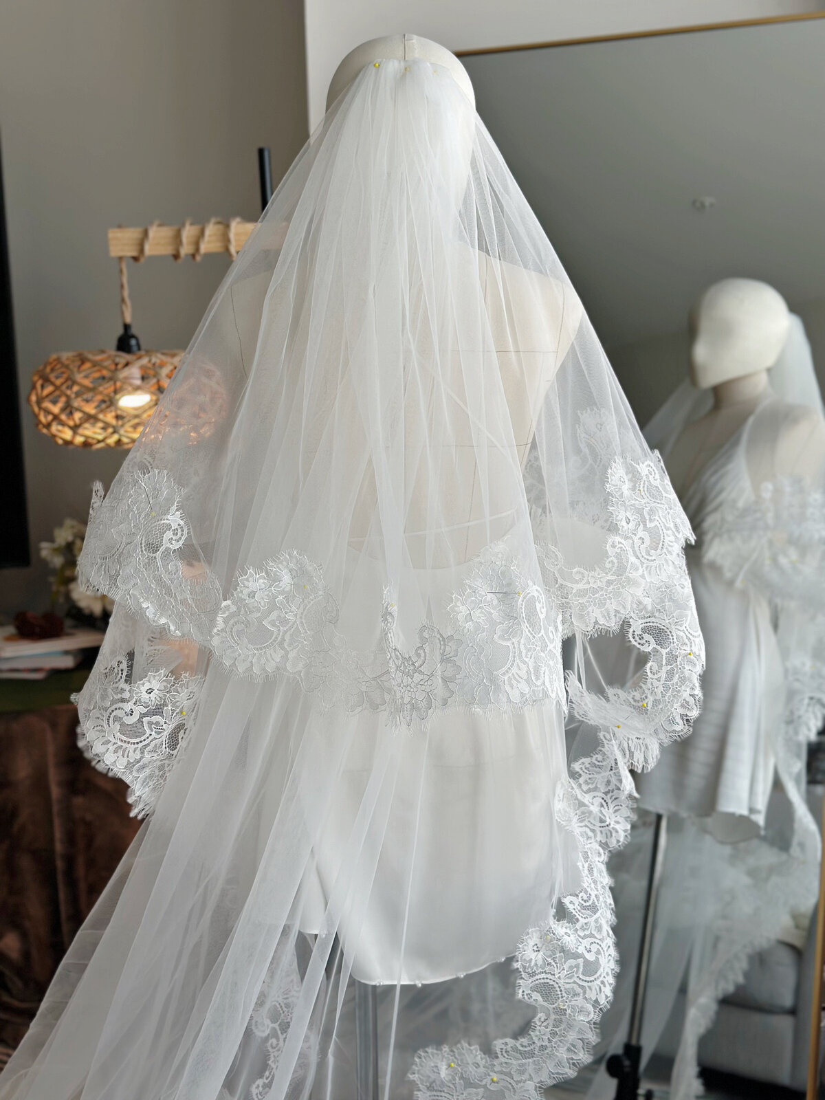 Blusher veil crafted from airy tulle with lace all around
