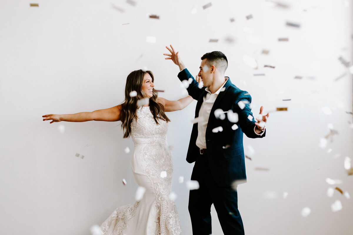 Bride and groom celebrating with confetti