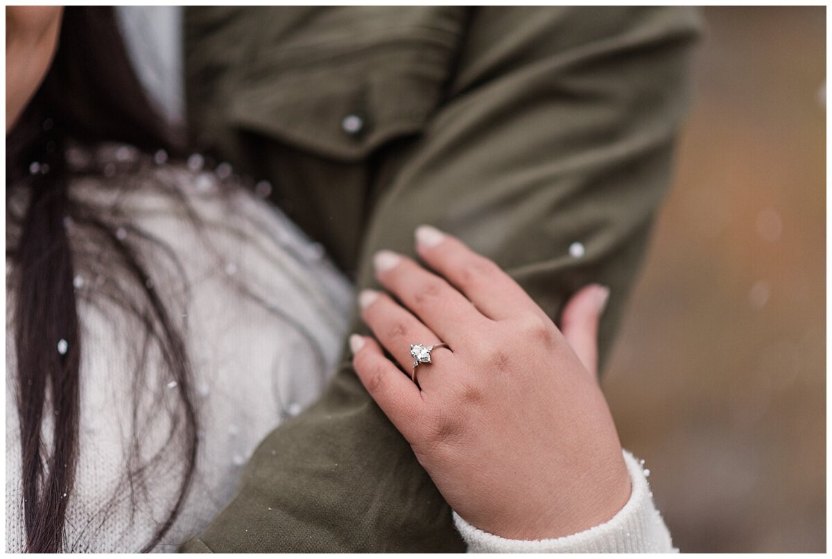 Ring shot of a woman's hand hanging on to her partner's arm