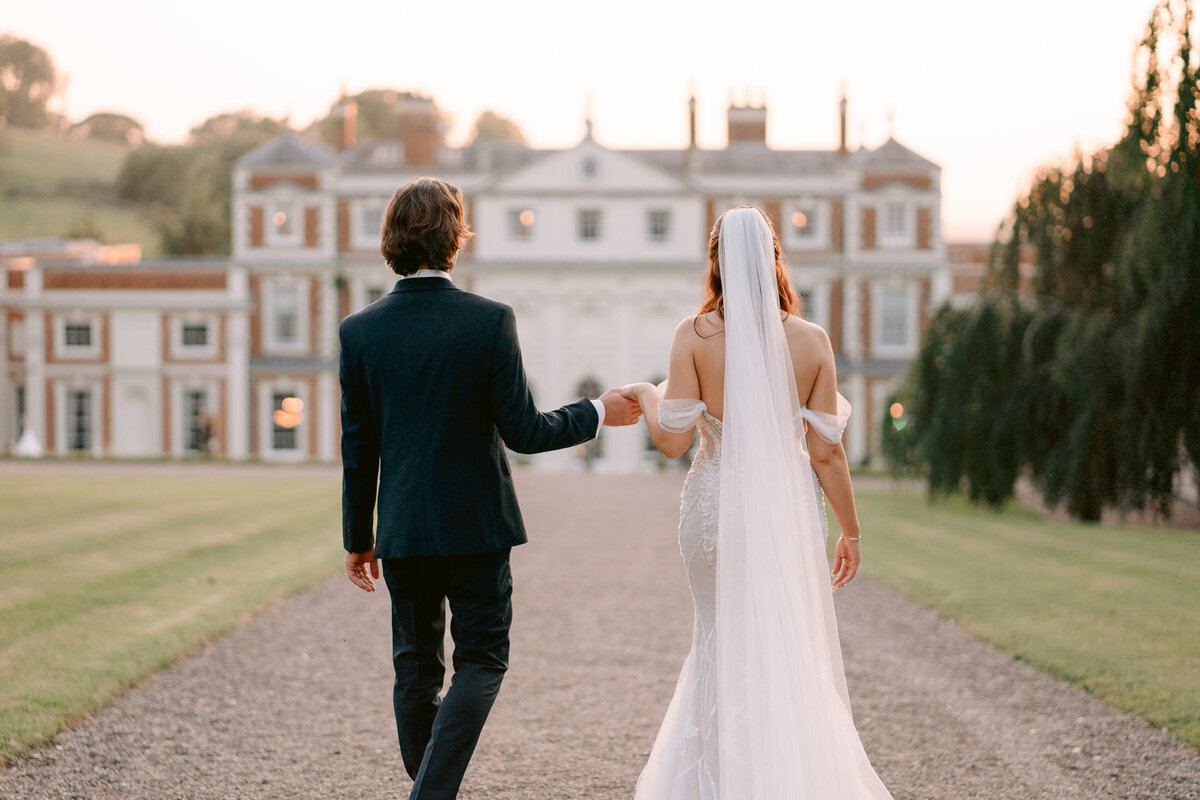 couple in golden light walking towards hawkstone