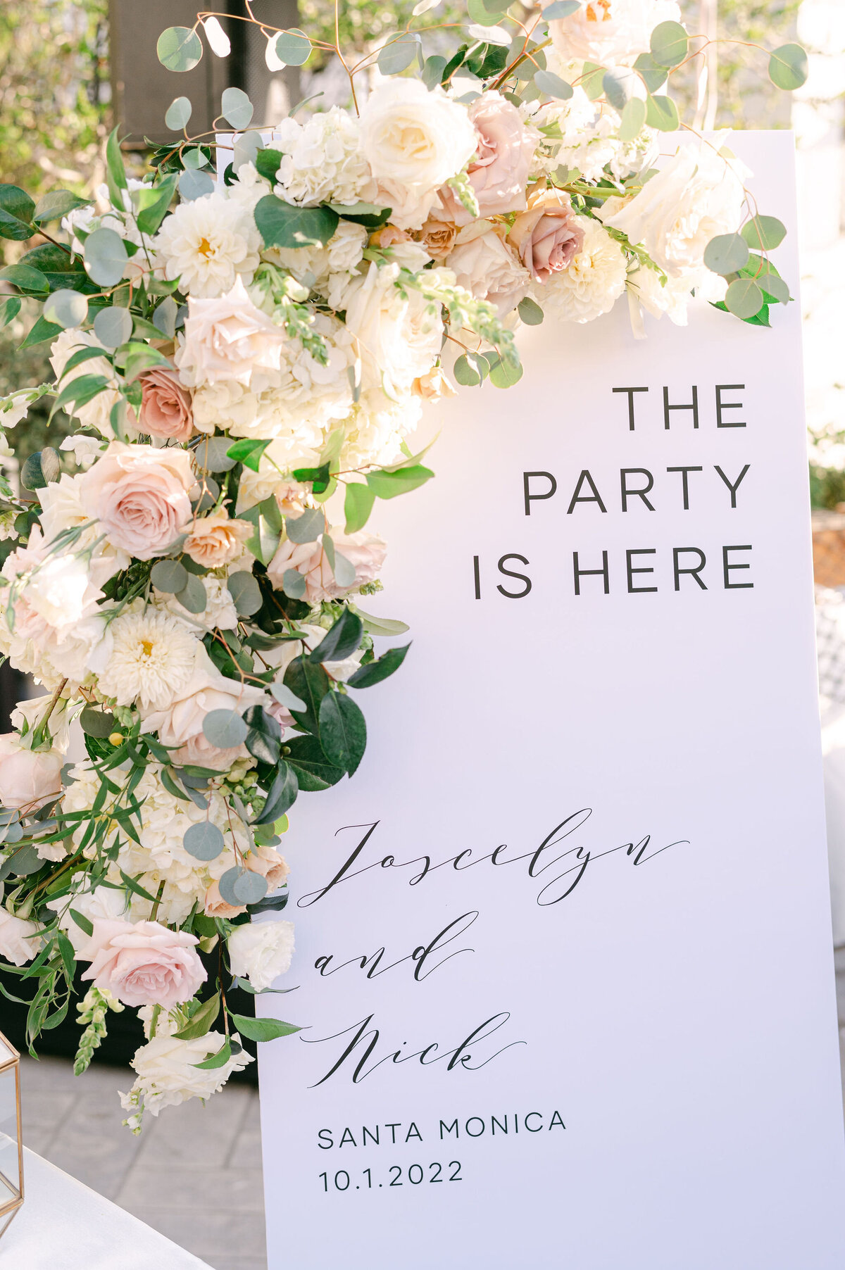 welcome sign with floral garland