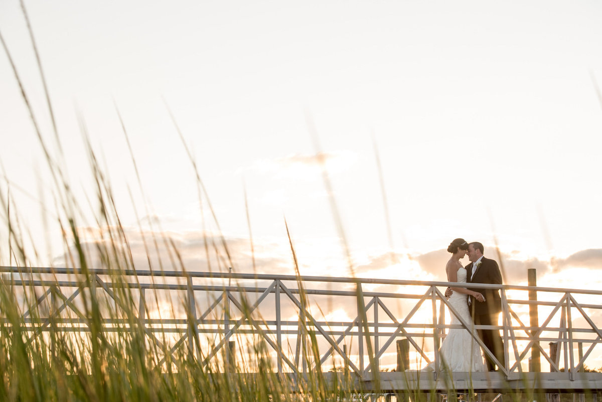 photo of bride and groom on the dock from wedding reception at Lawrence Yacht and Country Club