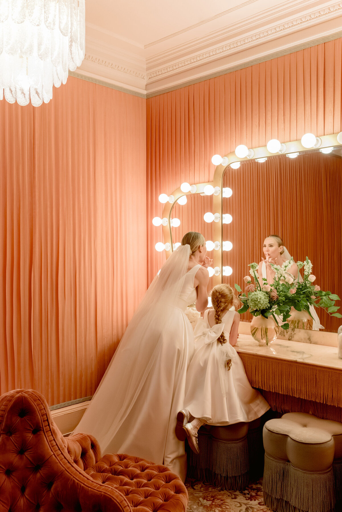 Bride and Flower girl in the Pink Powder Room of Gleneagles Hotel. Wedding flowers by Wild Burnett at Gleneagles on an intimate black tie wedding day. Image by luxury wedding photographer Scotland, Jill Cherry Porter.