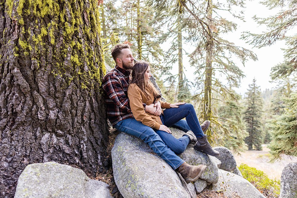 Adventure couple sitting on rocks on Mt Ashland