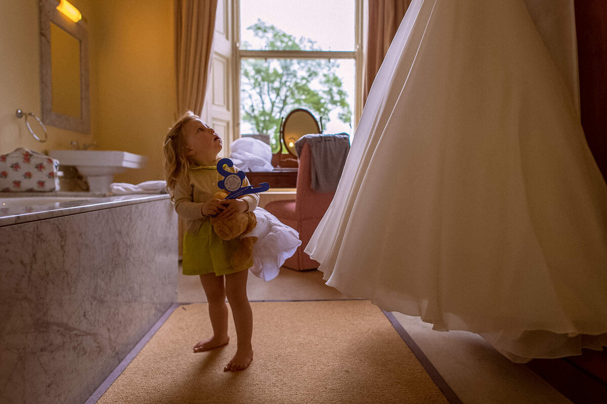 70 flowergirl-looks-up-to-bride