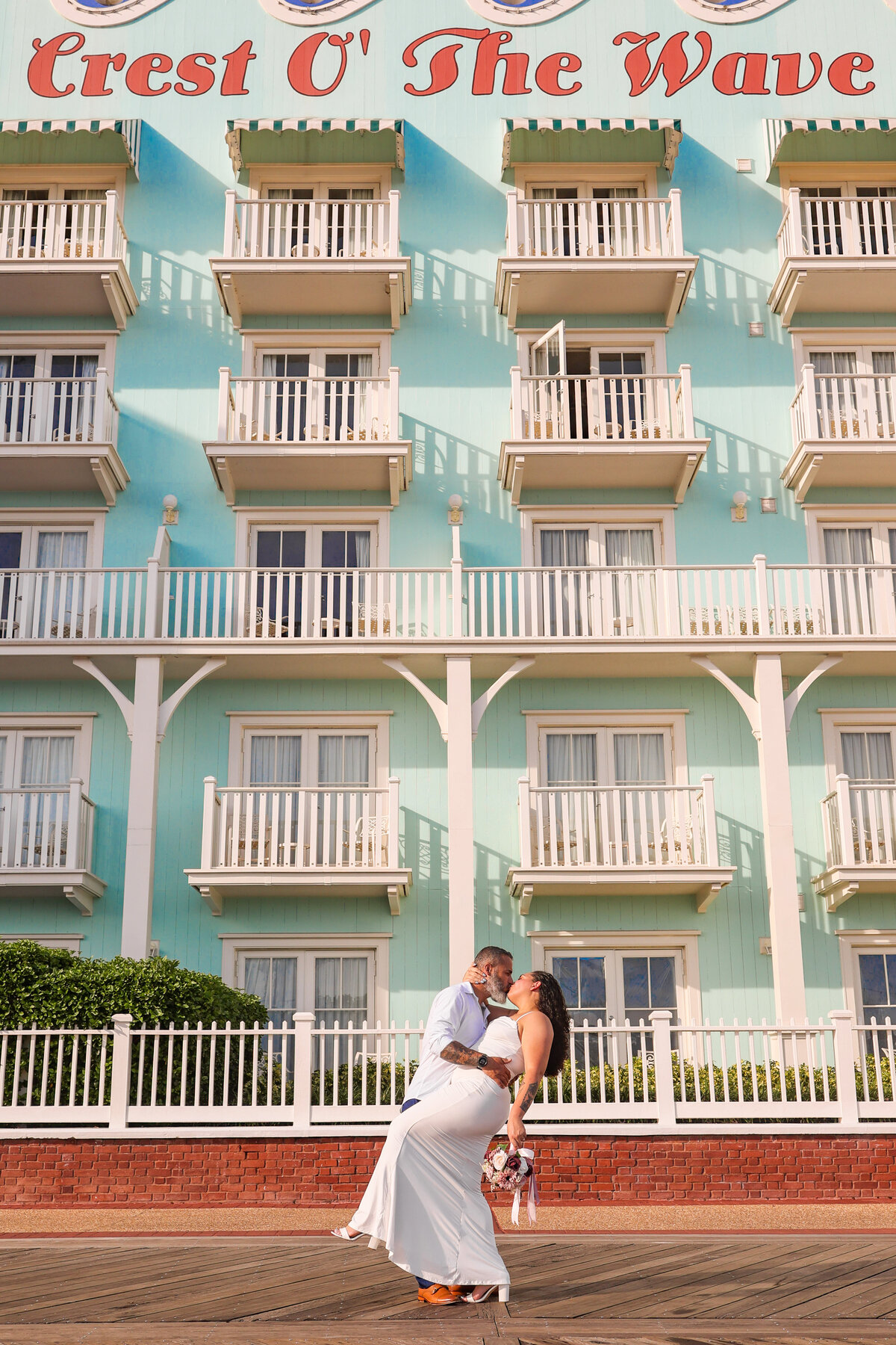 bride and groom kissing at Disney's Boardwalk hotel by Orlando Florida elopement photographer Amanda Richardson Photography