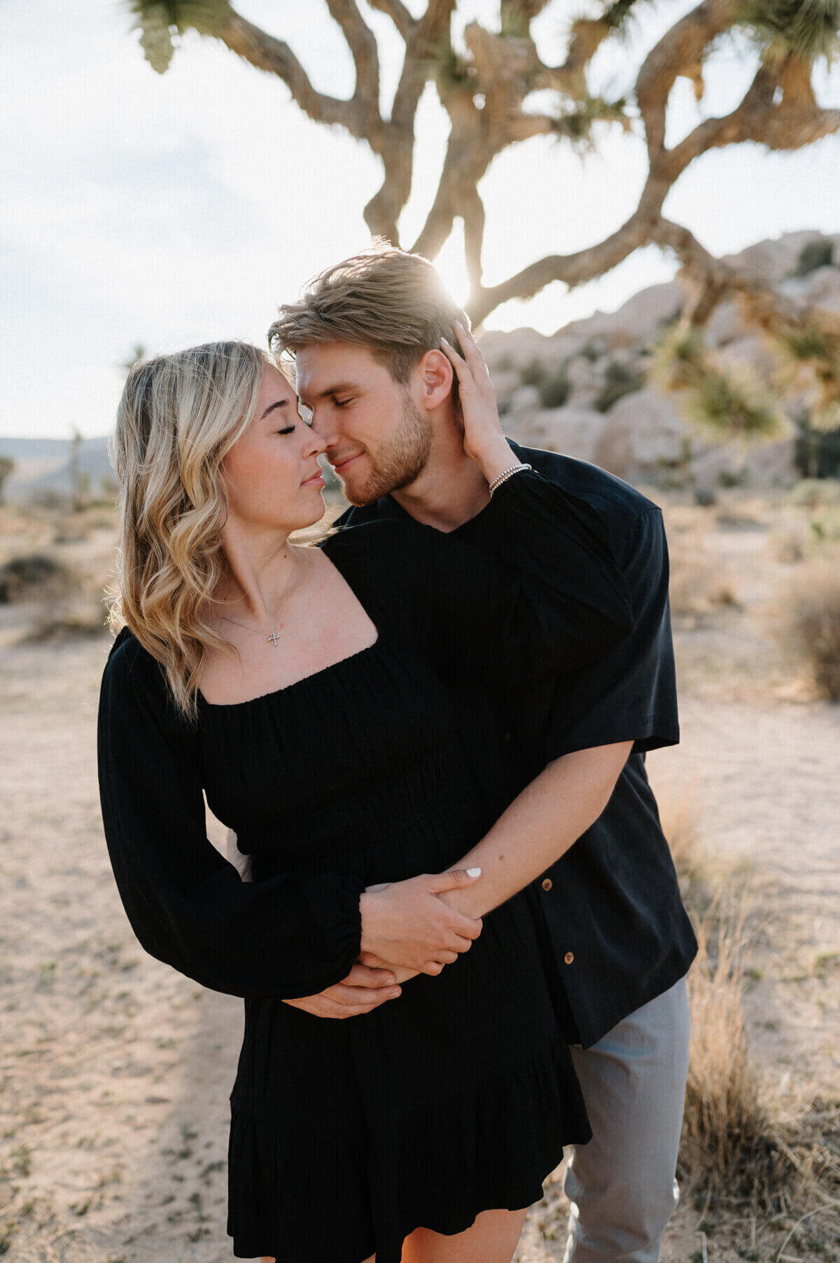 couple wearing black embracing taken by nashville engagement photographers