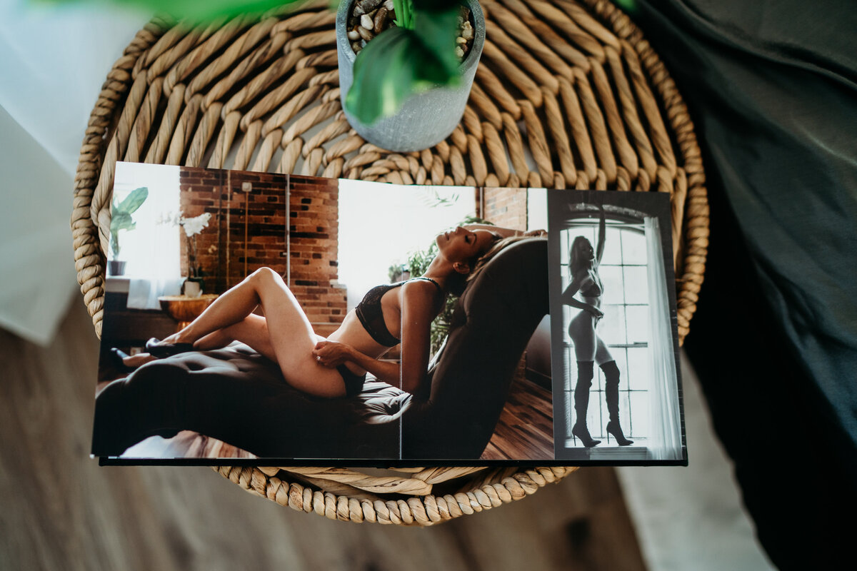 Details of an open photo album open to a centerfold luxury boudoir photo