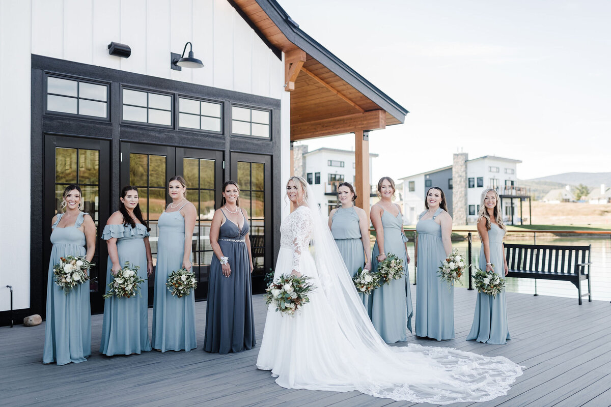 Blue-green bridesmaid dresses with white bouquets and accents of terracotta