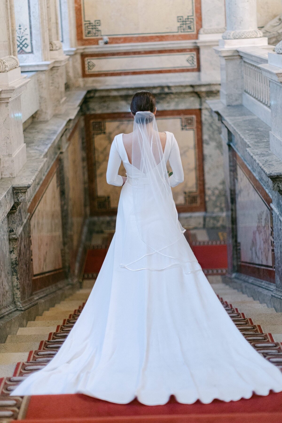 ECLAT Destination Weddings bride walking down the stairs at the imperial hotel in Vienna