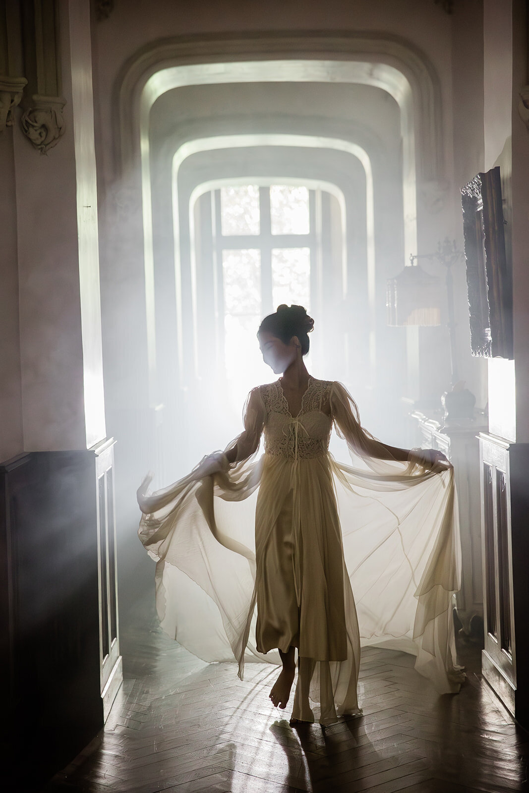 Bride posing in an artistic, fashion-forward Vogue-inspired style in the corridors of Château Challain, captured in elegant, natural wedding photography.
