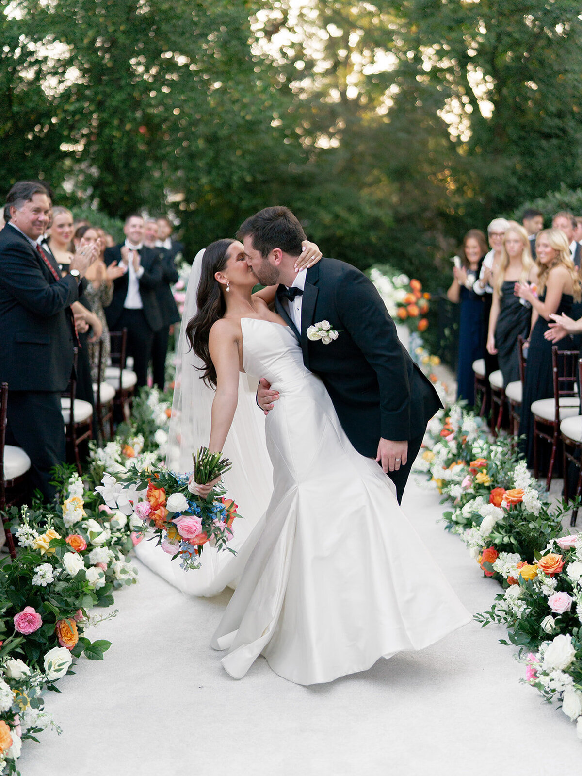 groom dips bride with a kiss