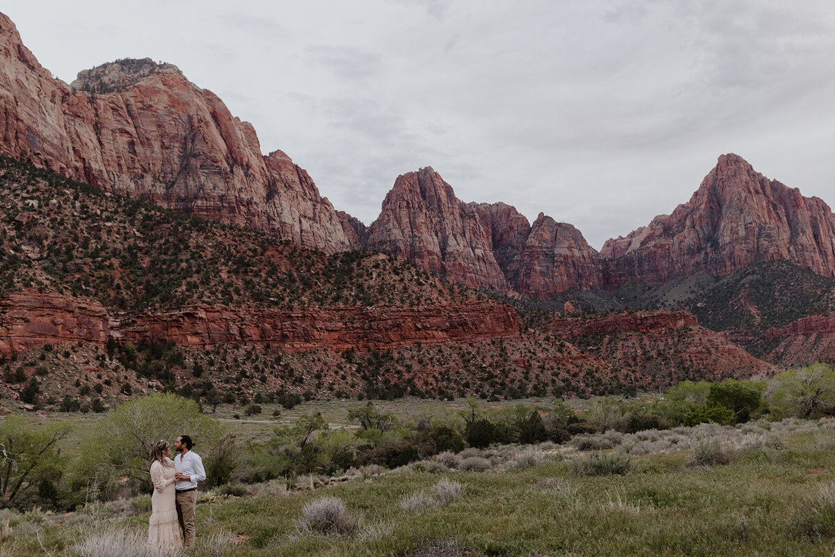 A couple standing in Zion National Park during their Utah Elopement. utah Elopement photographer