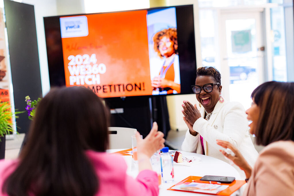 People deep in conversation excitedly sit around a table.