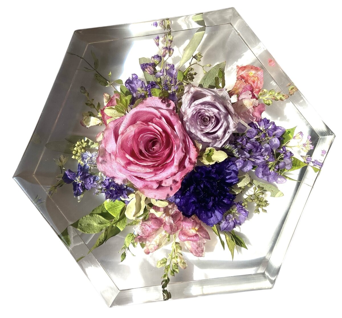 hexagon resin block with bright pink and purple funeral flowers preserved as a family heirloom
