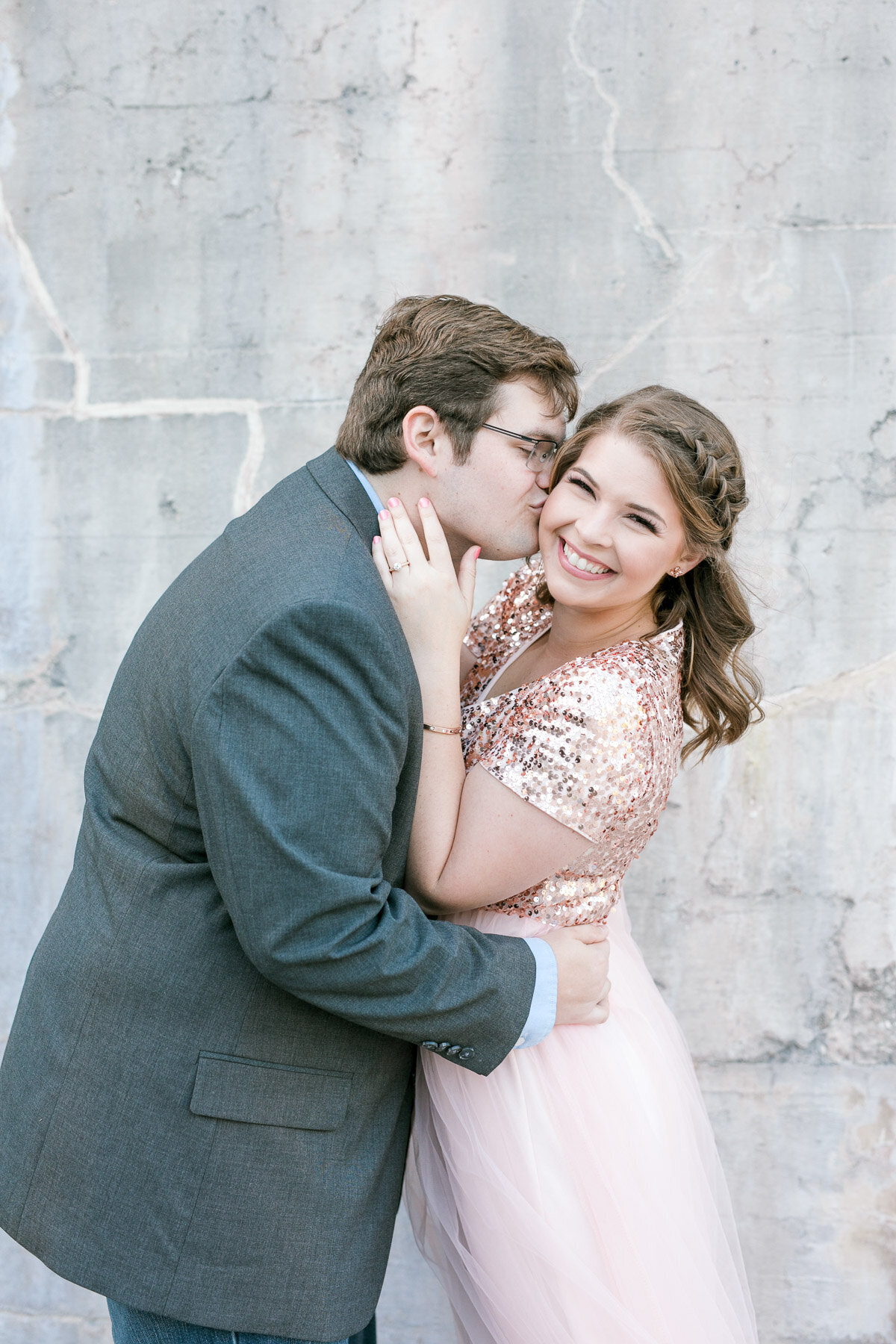 girl laughing boy kissing cheek