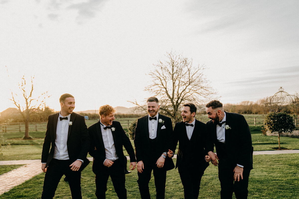 Natural golden hour portrait of groomsmen having a great time