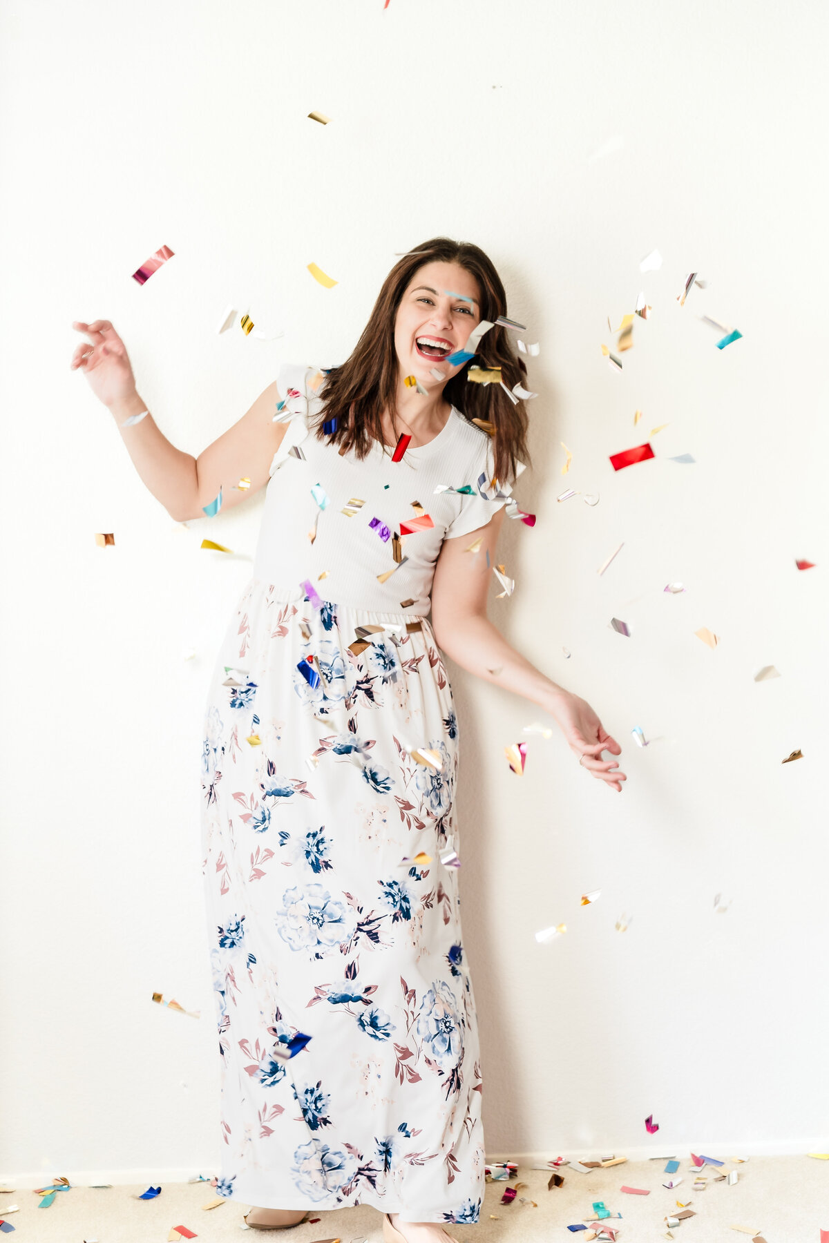 brand photo of a woman celebrating with confetti