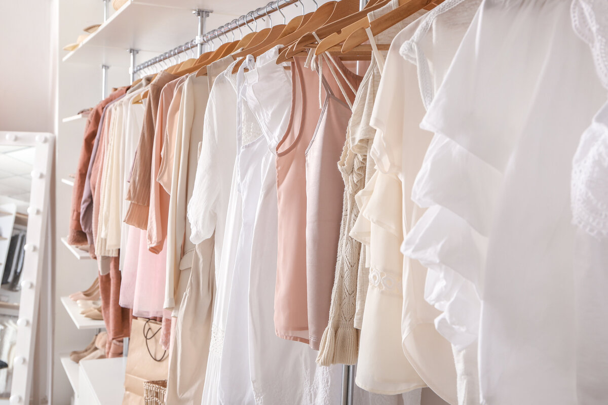 feminine closet with white and pink clothes