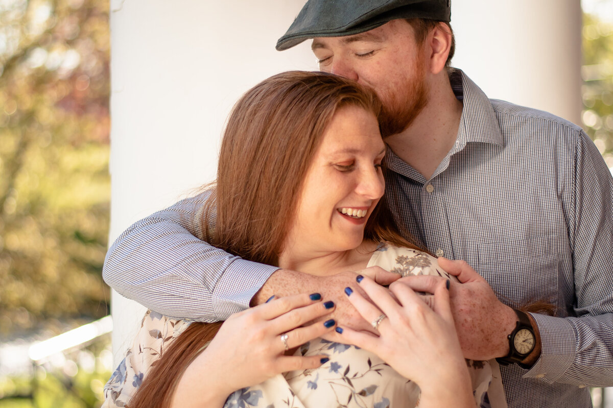 Experience the warmth and intimacy of a couple snuggling close in downtown Milford, Connecticut. Our photo captures their love story amidst the city's vibrant backdrop