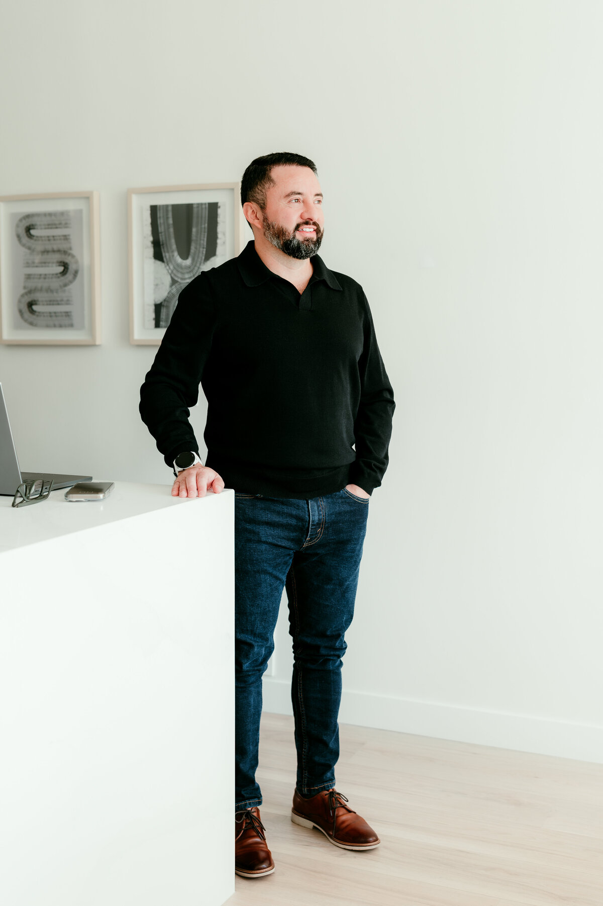 Professional natural light online dating photo of a man casually leaning on his kitchen counter in the Twin Cities, ideal for modern dating profiles.