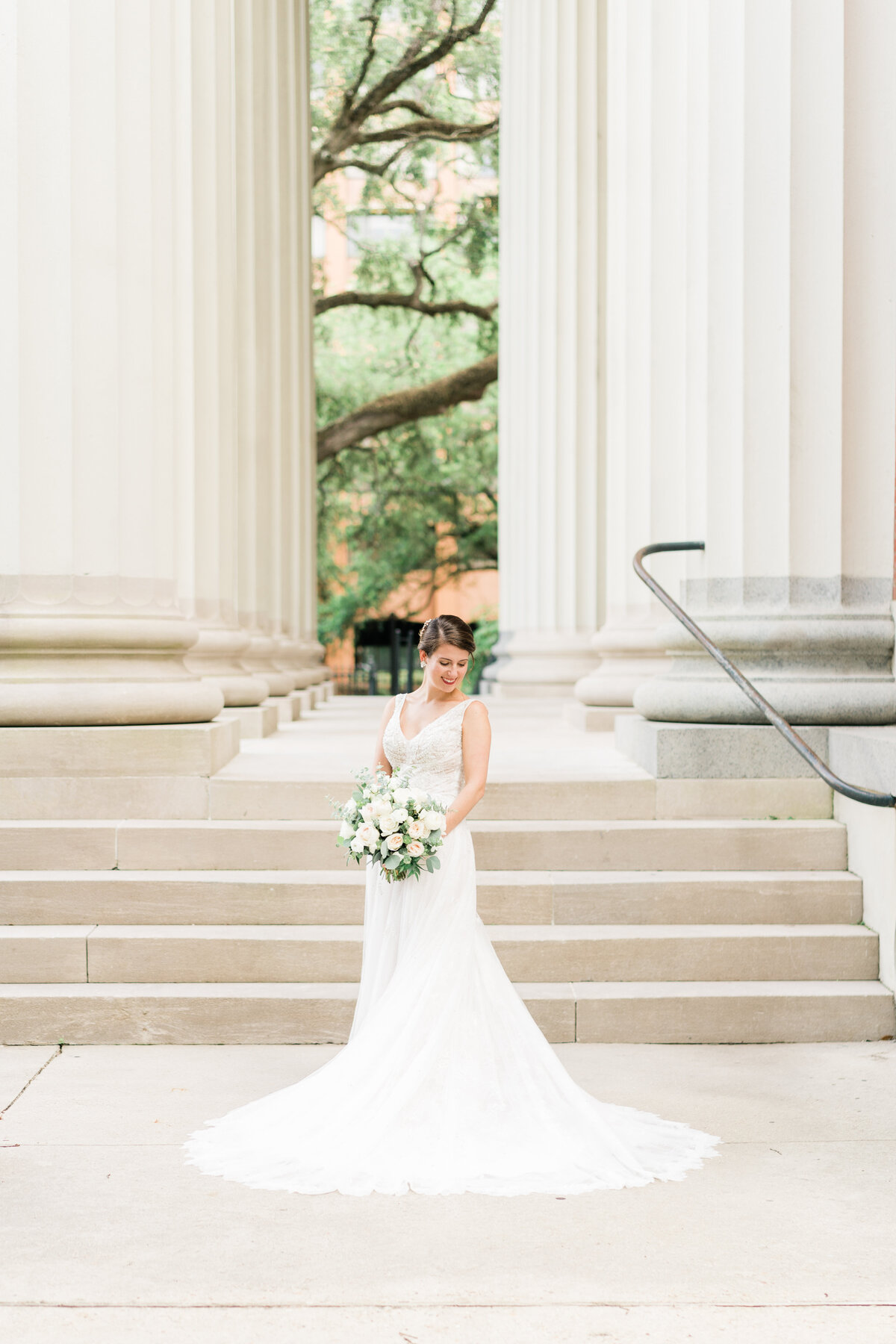 Bride standing in front of columns in Alabama