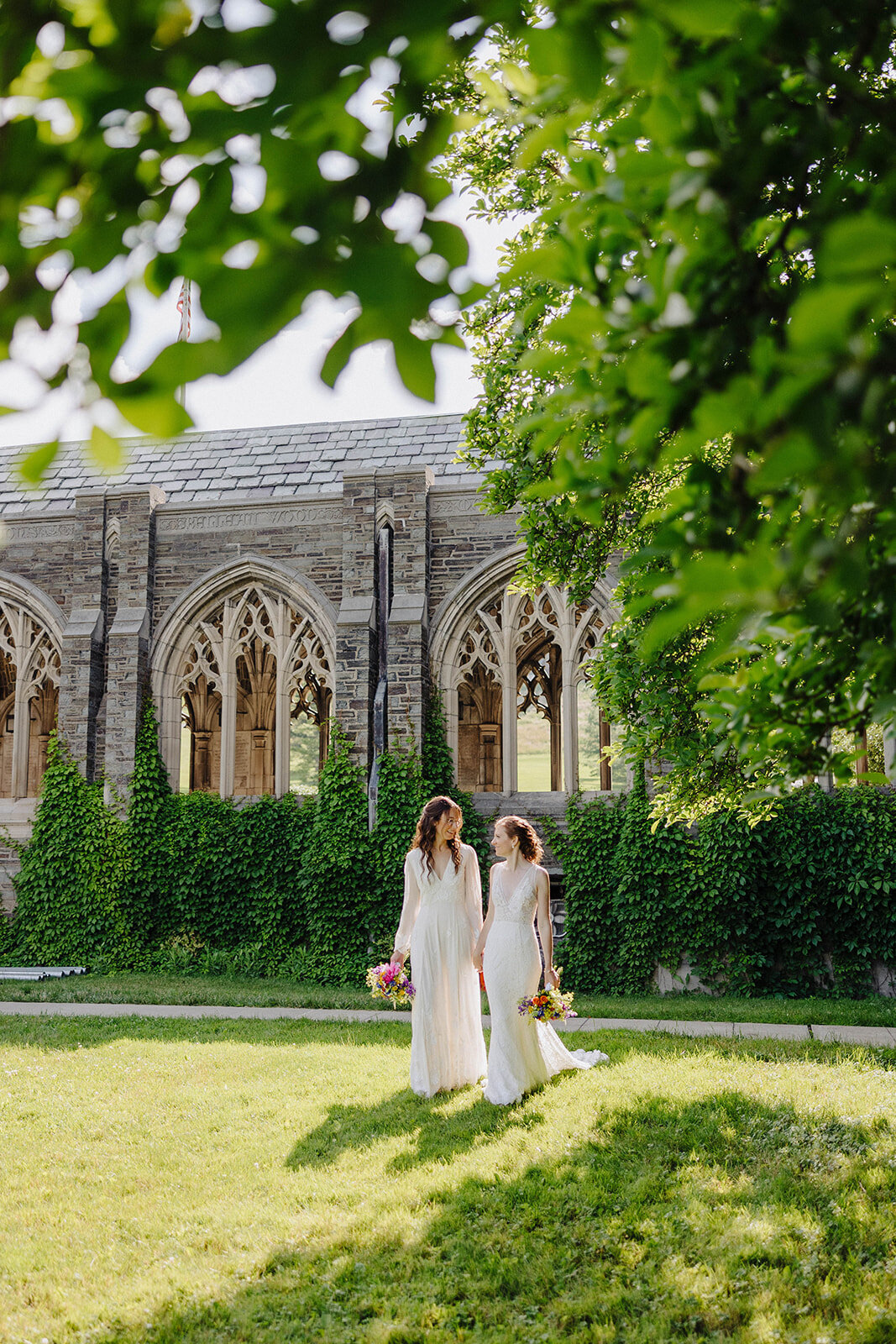 two brides walking though the grounds of Cornell University
