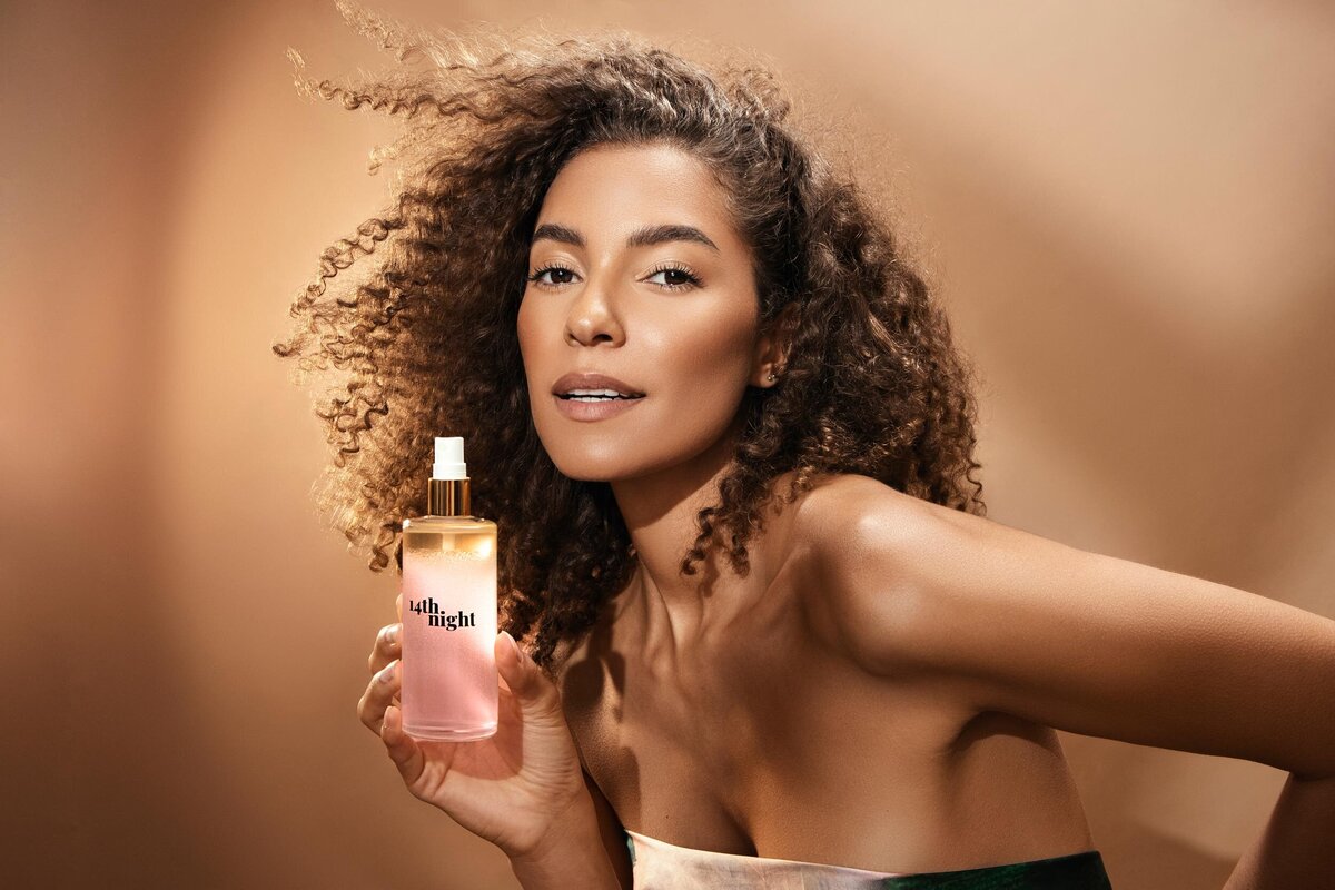 Angelica Artifex in a striking portrait with voluminous curls and bold styling, captured by Ylva Erevall.