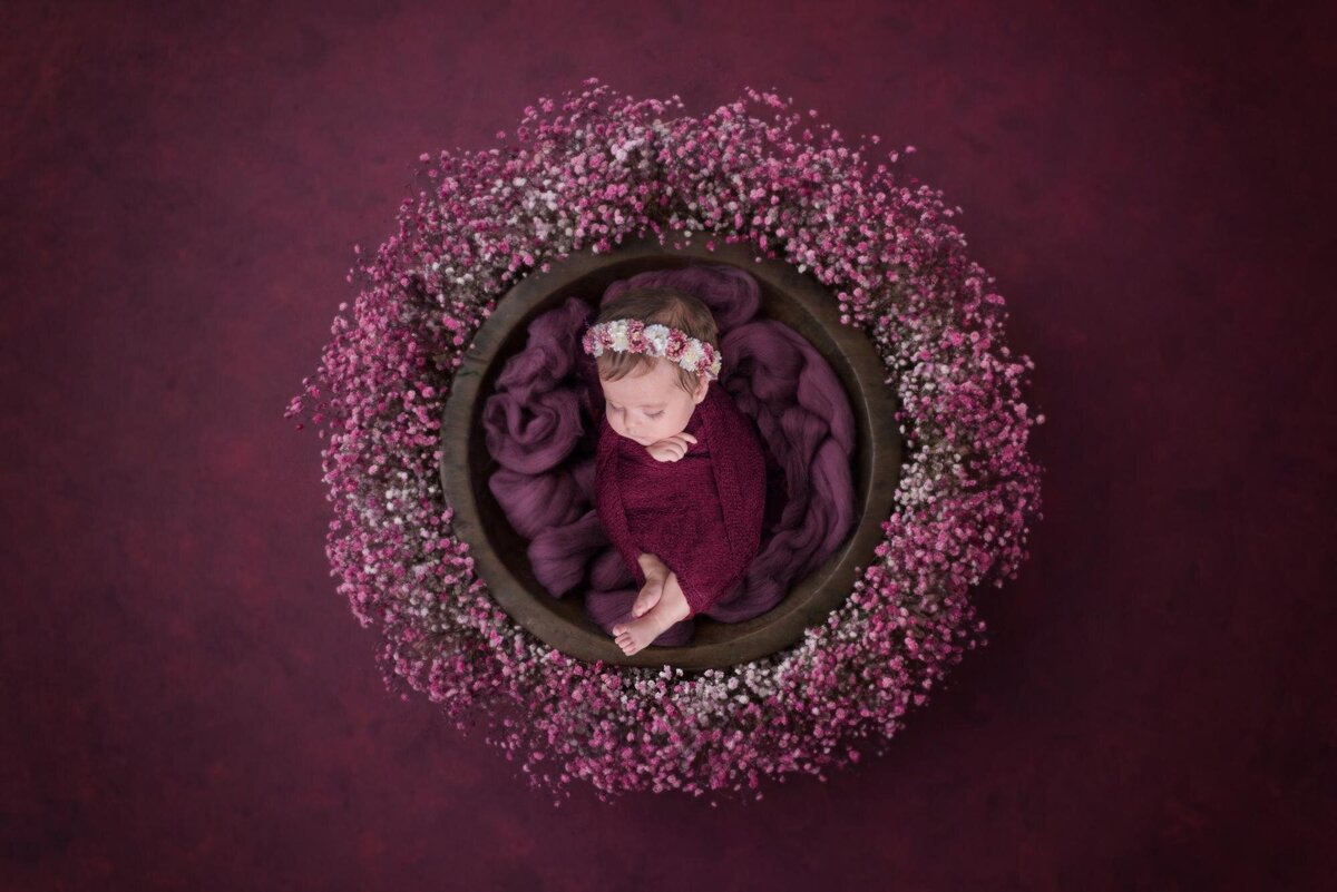 baby girl in a purple floral basket