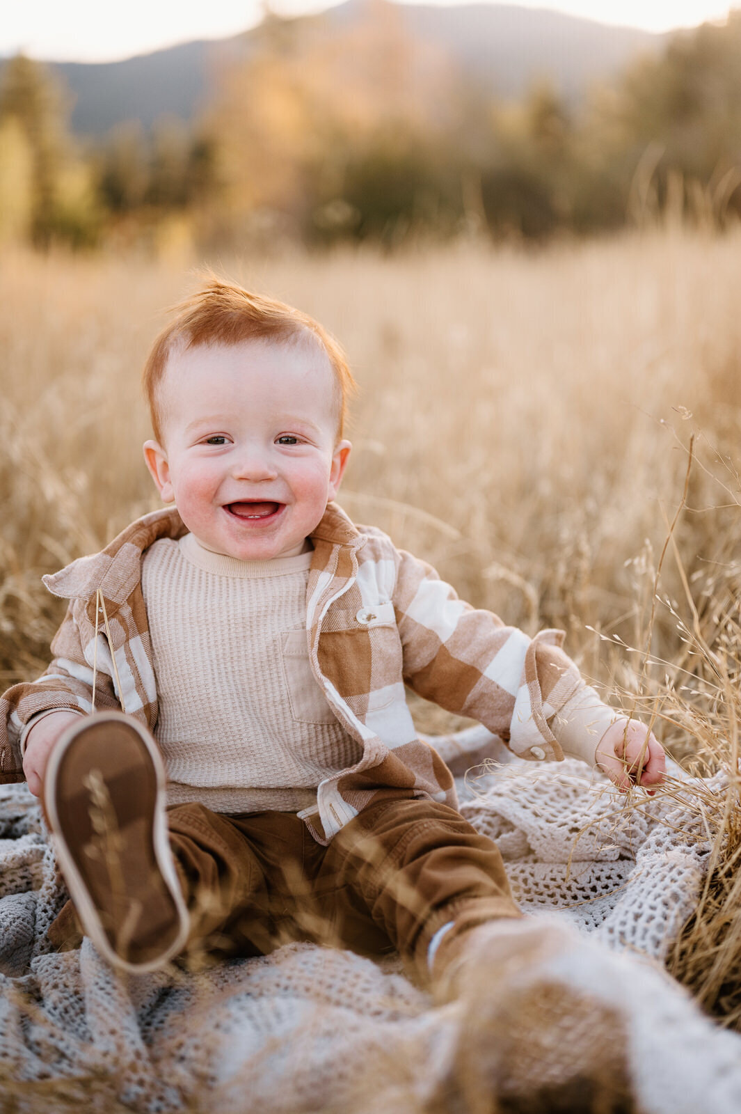Happy baby sitting in a field