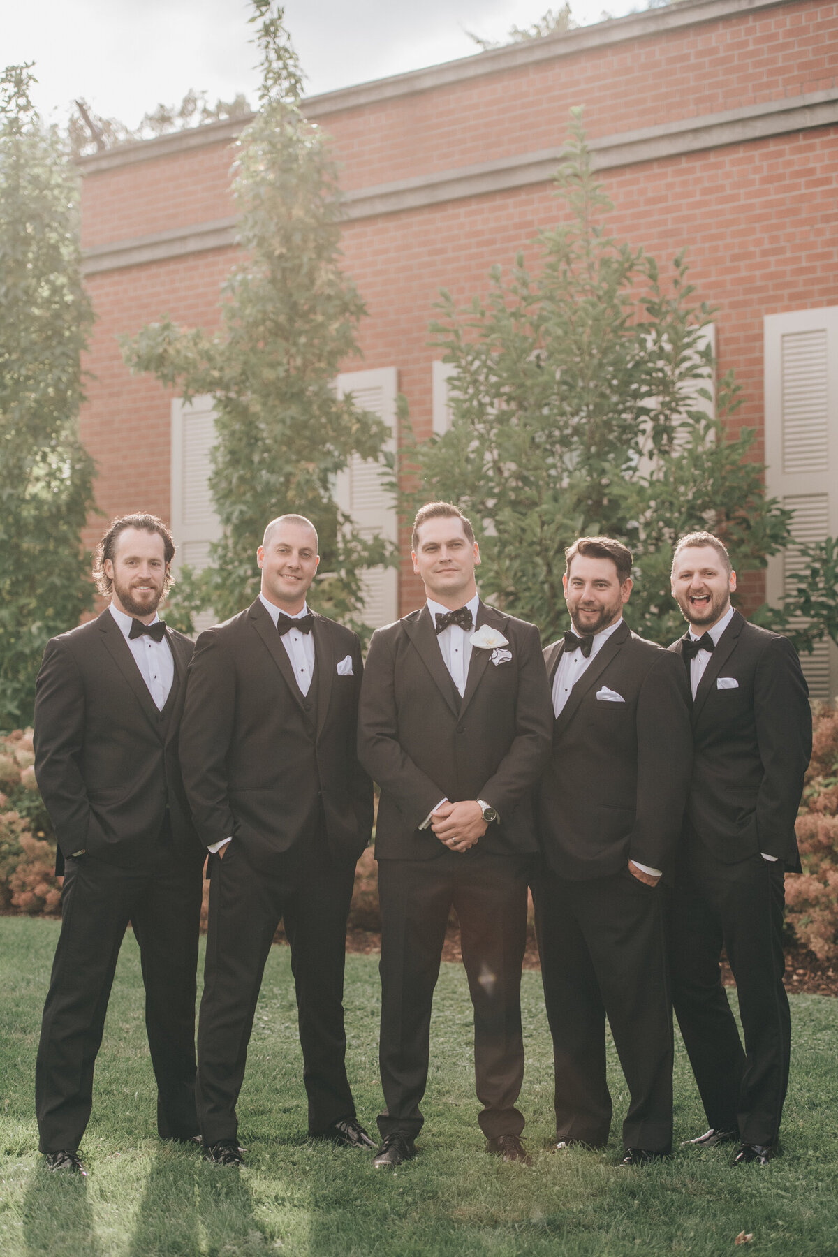 Groomsmen in black tuxedos for traditional groomsmen photos