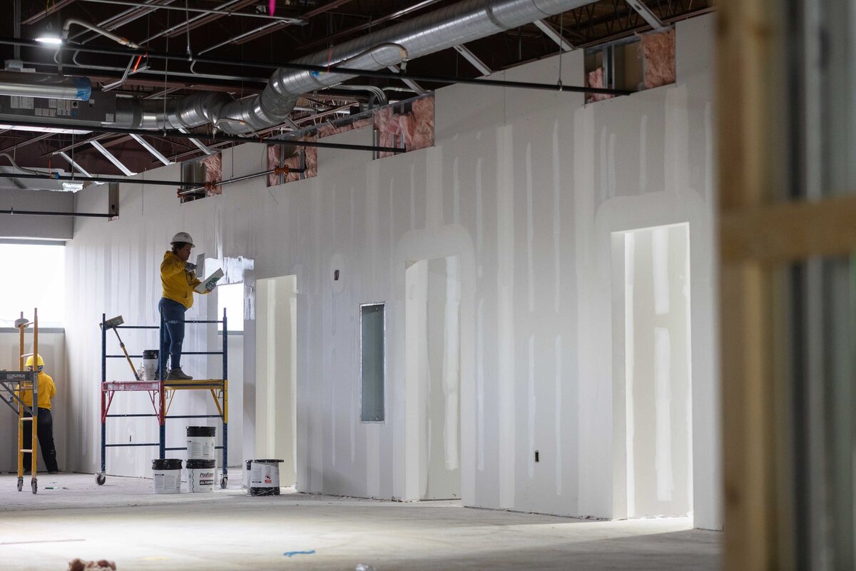 photo of johnson city commercial drywall finishers on scaffolding j.ross