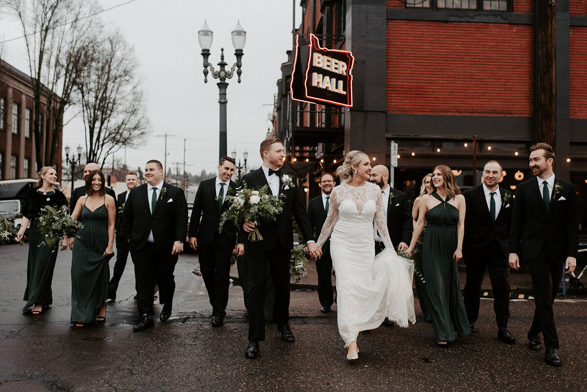 Bride and groom with their entourage crossing the street outside the Evergreen Events Space