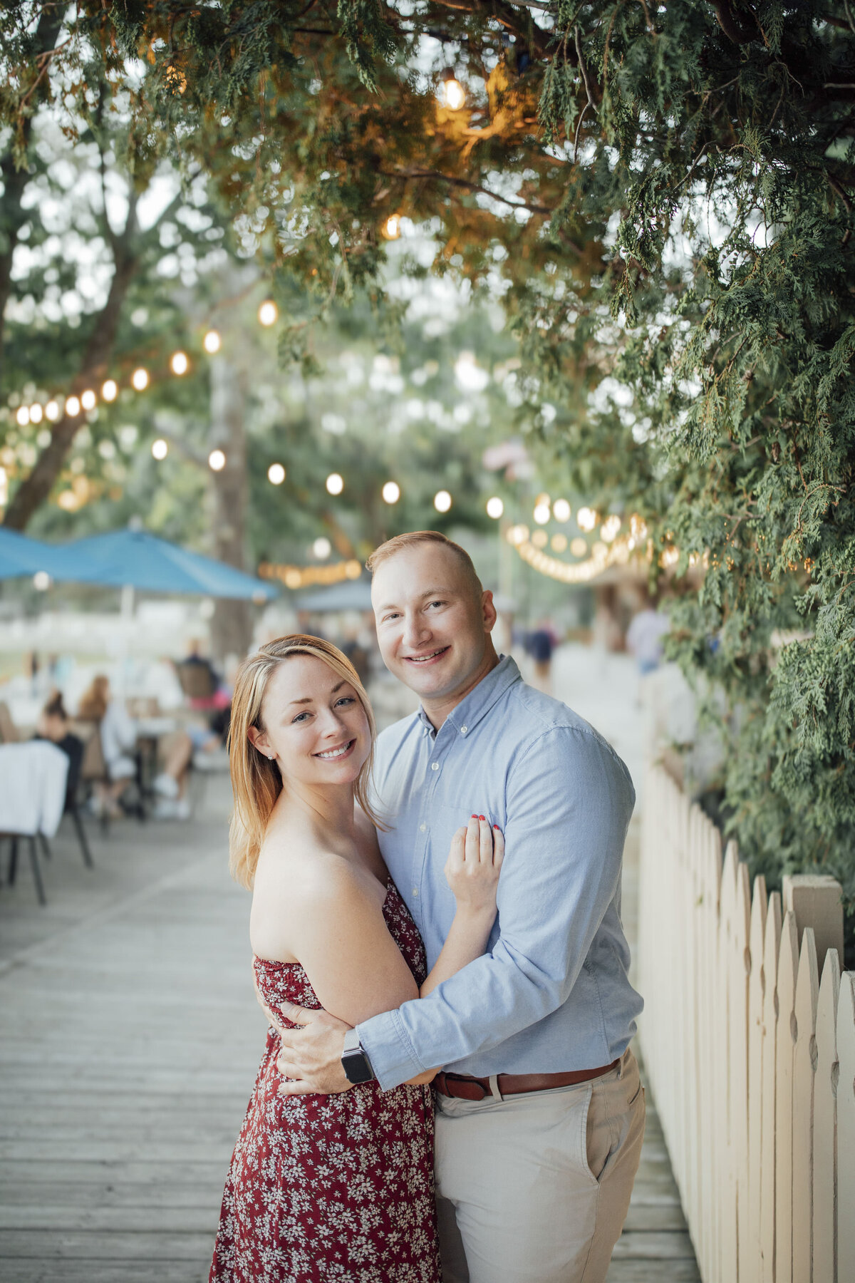 Couple smiling on boardwalk during engagement photo at Lake Mohawk in Sparta New Jersey