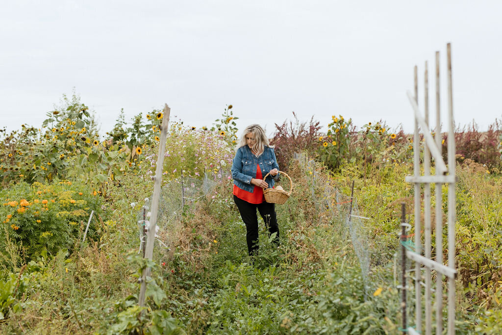 women standing in a field of sunflowers