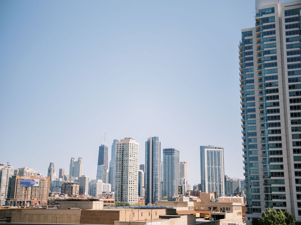 A breathtaking view of the Chicago skyline with modern high-rises and a bright blue sky.