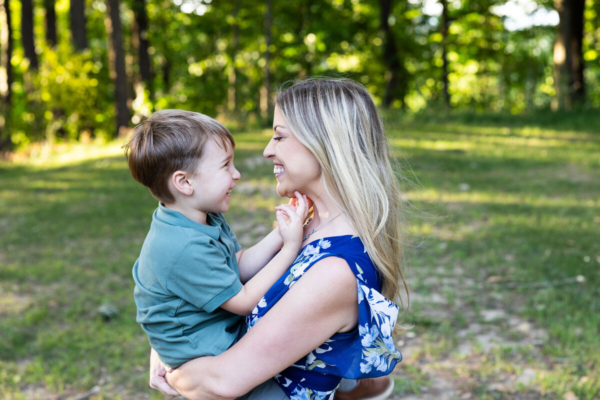 Mother and son hold in arms for family session in murrysville