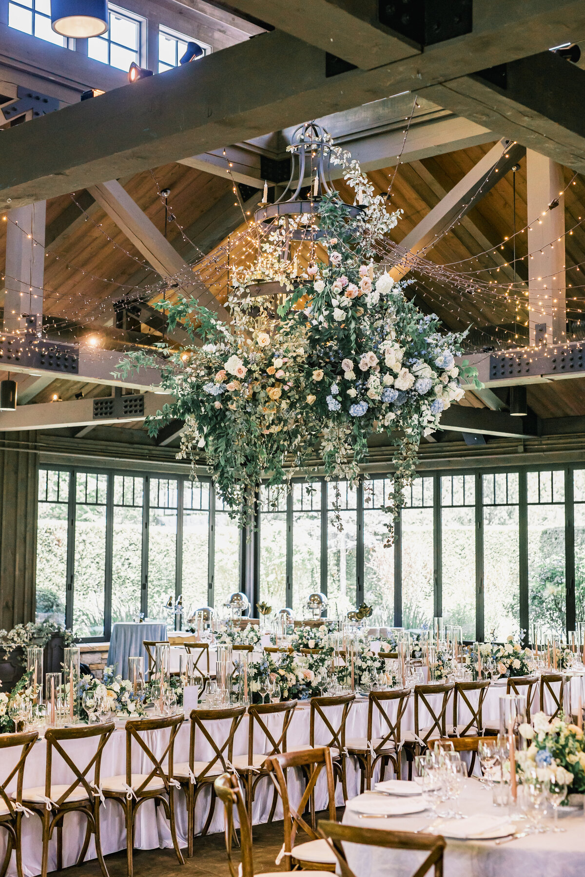 Reception tablescape featuring hanging floral chandelier, candlelight, and elegant florals at Old Edwards Inn in Highlands, North Carolina.