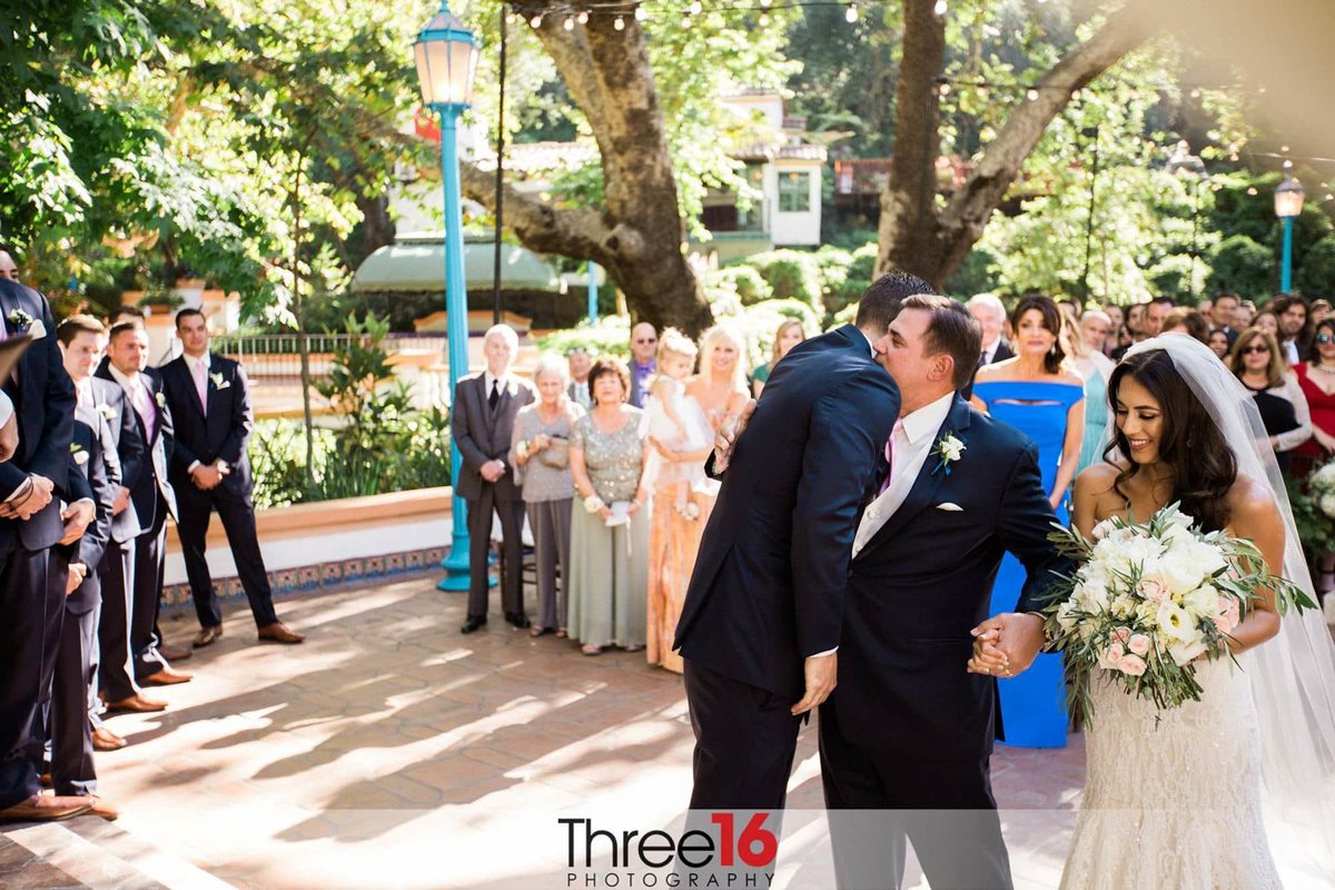 Groom hugs father of the Bride