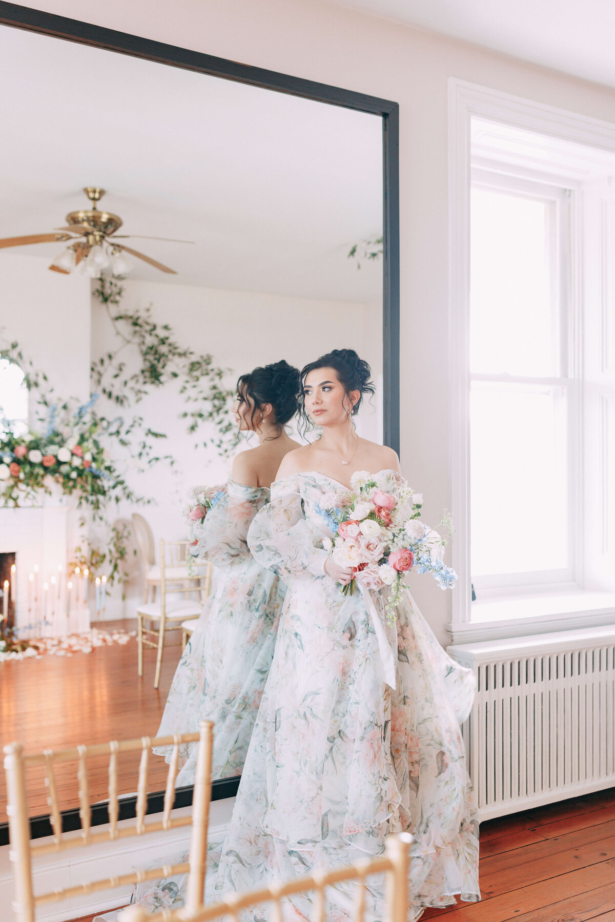bride wearing floral dress standing in front of mirror