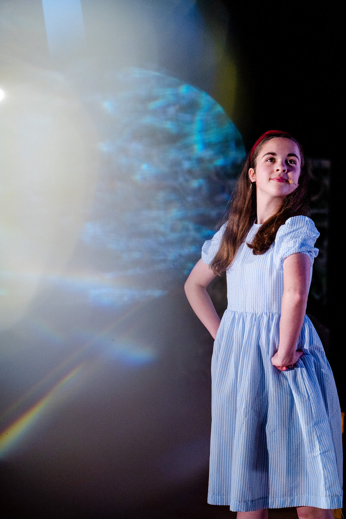 a girl playing Matilda looking off camera during a live performance