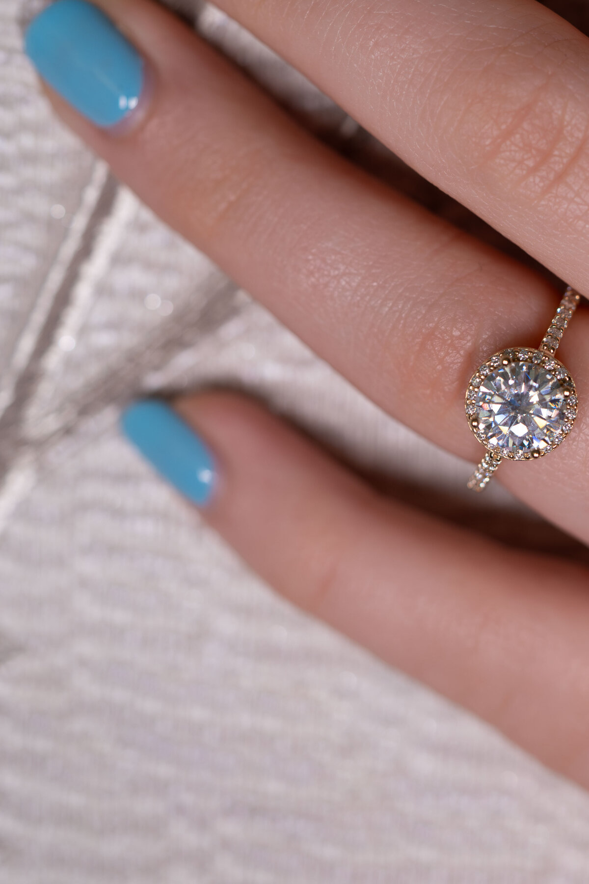 Round brilliant diamond set in 14k gold halo ring