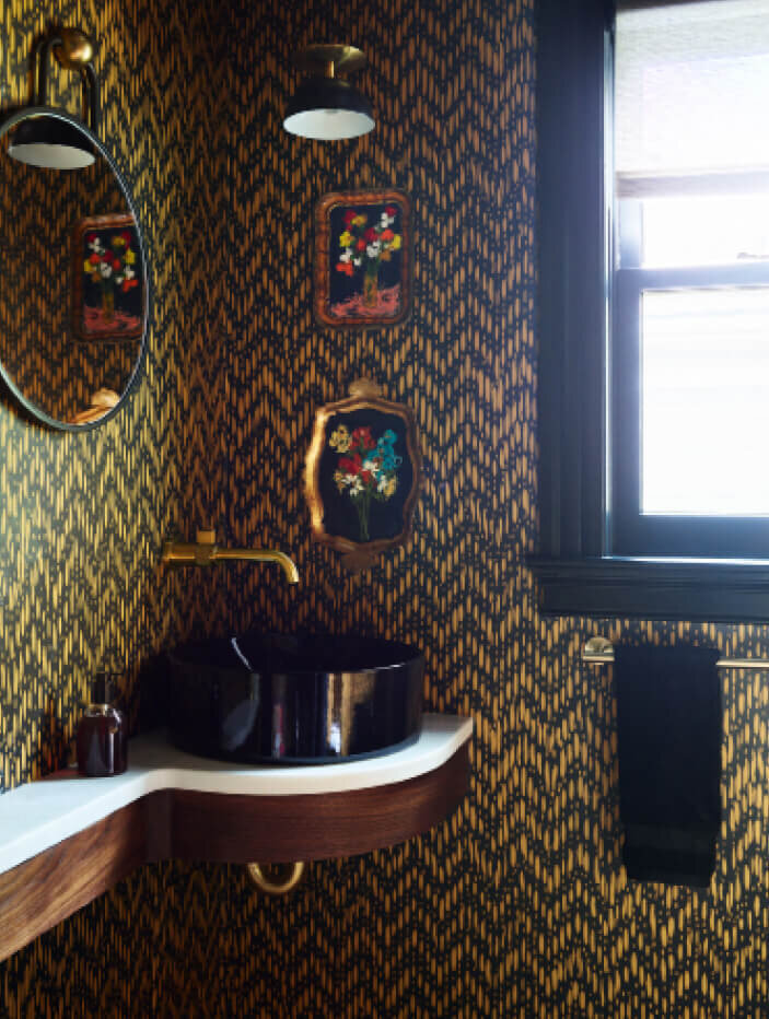 Powder room design with Pierre Frey black and gold wallpaper in a Brookline historic home renovation, blending classic architecture with bold, modern style.