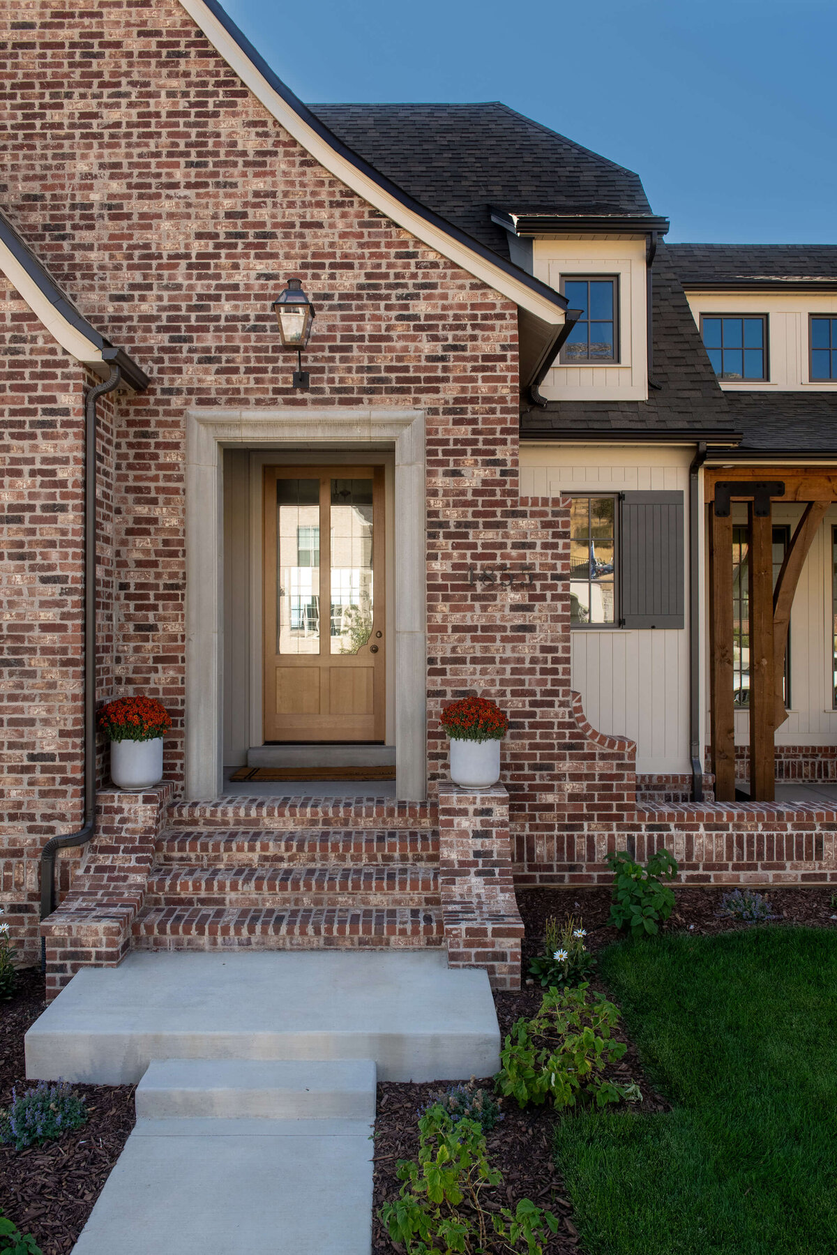dutch-tudor-front-entry-red-brick-and-arched-door