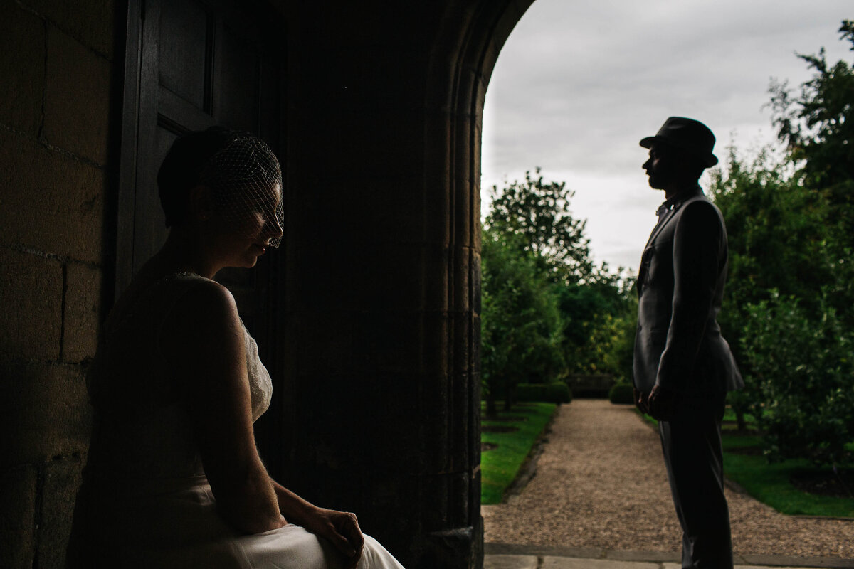 A creative portrait of a bride and groom at East Riddlesden Hall