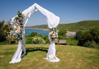 A wedding arch decorated with flowers and greenery