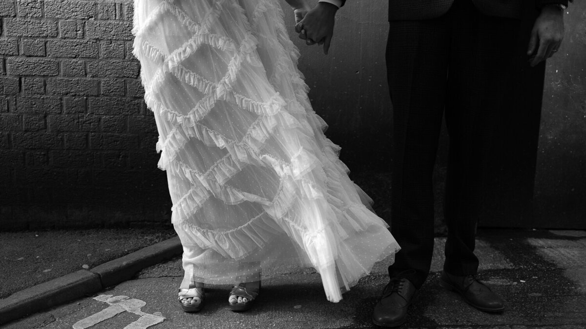 Detail shot of a bride and grooms legs and dress detail at Trafalgar Warehouse in Sheffield.